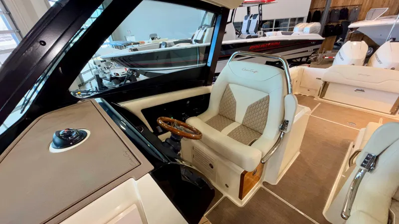 Slide: The Image of 2024 Chris-Craft Calypso 32 CT interior with luxurious captain's seat and steering wheel. - 28
