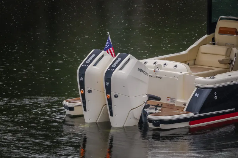 Slide: The Image of 2024 Chris-Craft Calypso 32 boat with dual Mercury outboard engines on water. - 17