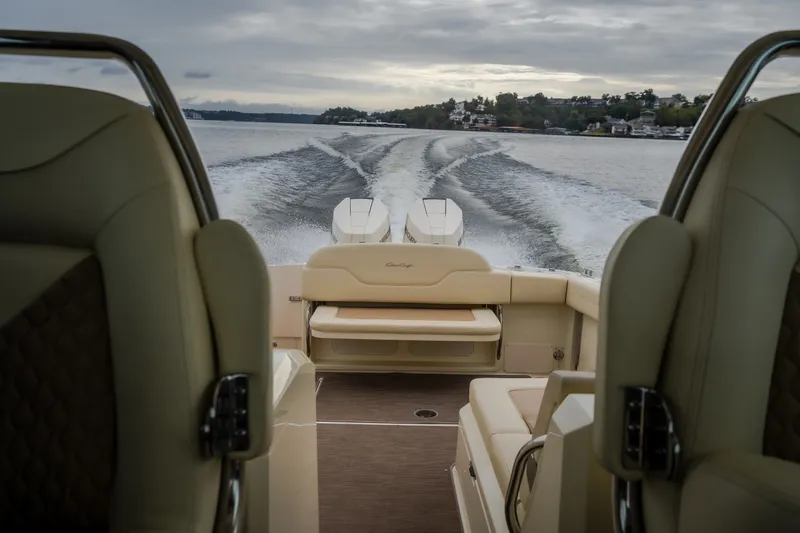 Slide: The Image of 2024 Chris-Craft Calypso 32 cruising on a lake, showcasing luxurious seating and powerful engines. - 60