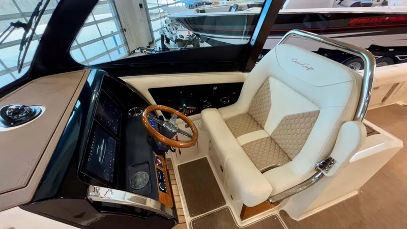 Slide: The Image of 2024 Chris-Craft Calypso 32 CT helm with luxurious seating and modern dashboard. - 32