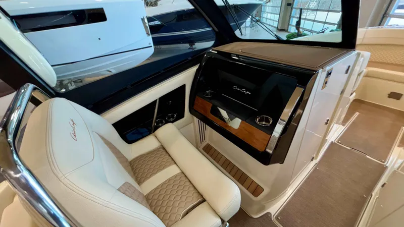 Slide: The Image of 2024 Chris-Craft Calypso 32 CT interior with luxurious seating and modern dashboard. - 34
