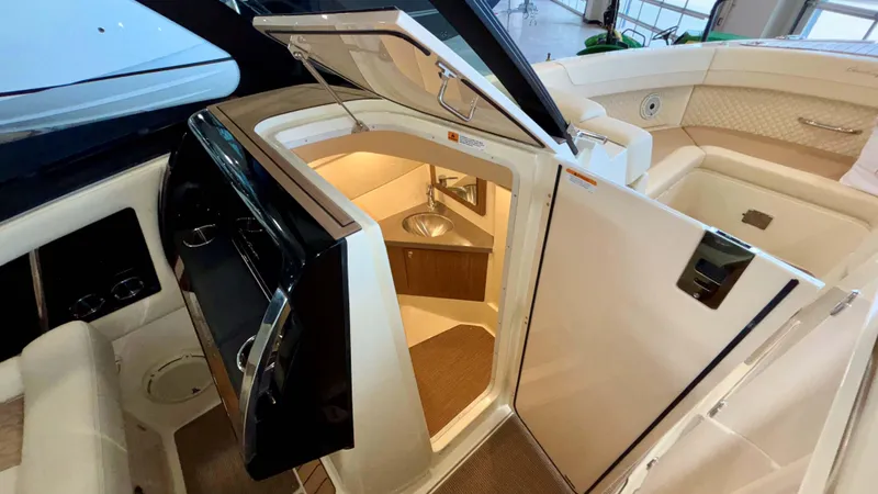 Slide: The Image of 2024 Chris-Craft Calypso 32 CT interior with open cabin door and sink. - 35