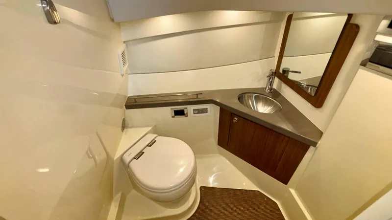 Slide: The Image of 2024 Chris-Craft Calypso 32 CT boat bathroom with modern fixtures and wooden accents. - 37