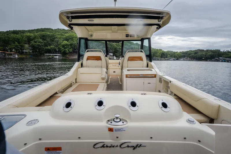 Slide: The Image of 2024 Chris-Craft Calypso 32 boat interior with seating, on a serene lake. - 20
