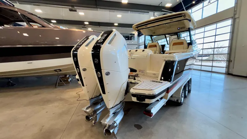 Slide: The Image of 2024 Chris-Craft Calypso 32 CT boat with dual engines in a showroom. - 4