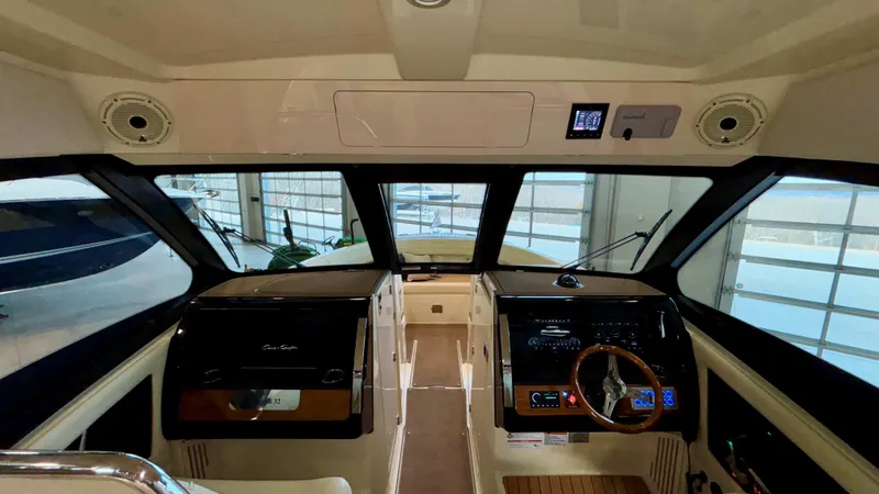 Slide: The Image of 2024 Chris-Craft Calypso 32 CT interior cockpit with modern controls and steering wheel. - 43