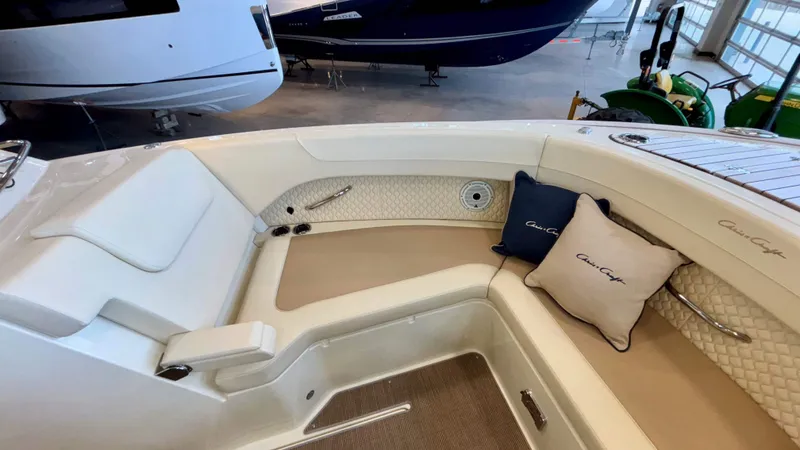 Slide: The Image of 2024 Chris-Craft Calypso 32 CT boat interior with cushioned seating and branded pillows. - 45