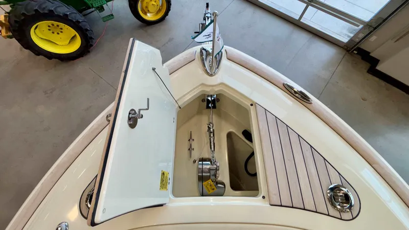Slide: The Image of 2024 Chris-Craft Calypso 32 CT boat anchor compartment, open lid, indoor display. - 47