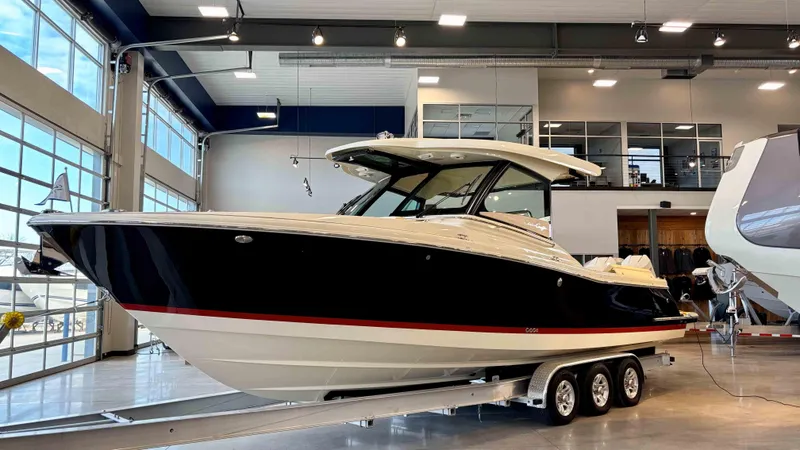 Slide: The Image of 2024 Chris-Craft Calypso 32 CT boat displayed indoors on a trailer. - 5