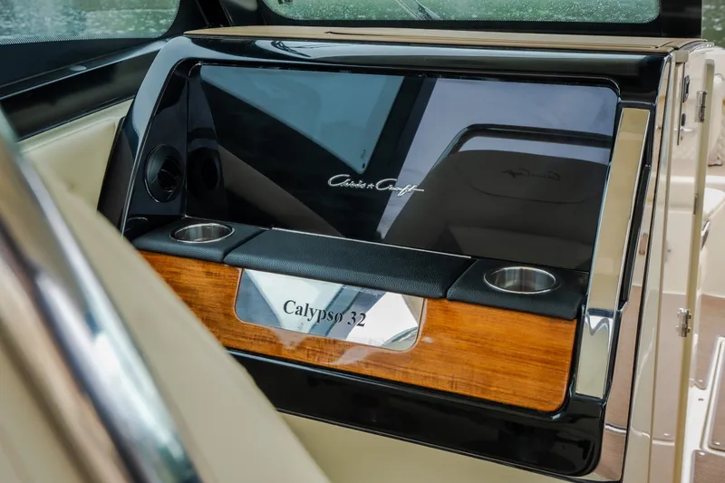 Slide: The Image of 2024 Chris-Craft Calypso 32 dashboard with elegant wood and chrome accents. - 46