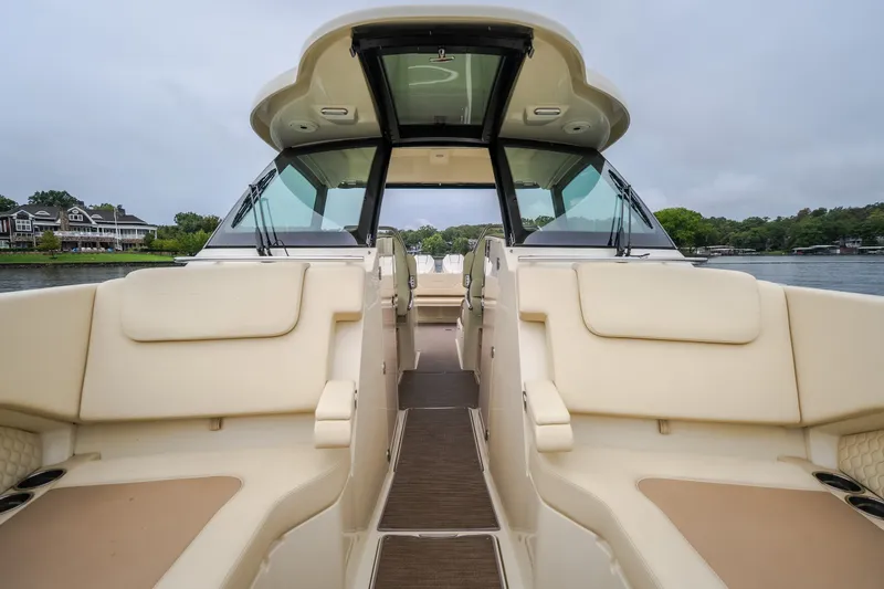 Slide: The Image of 2024 Chris-Craft Calypso 32 boat interior with beige seating and sleek design. - 57