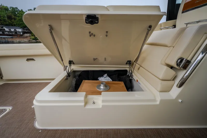 Slide: The Image of 2024 Chris-Craft Calypso 32 boat storage compartment with open lid, showcasing interior space. - 24