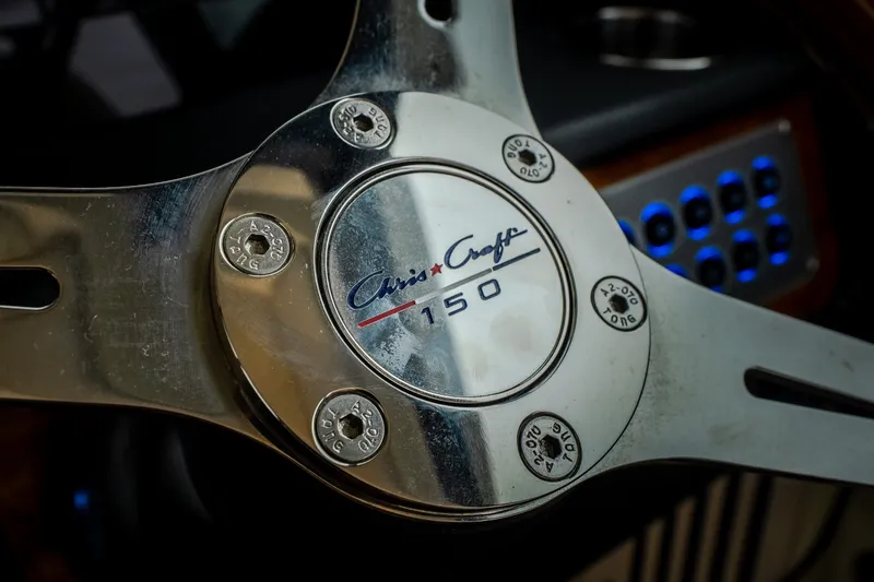 Slide: The Image of Close-up of 2024 Chris-Craft Calypso 32 steering wheel with logo and controls. - 35