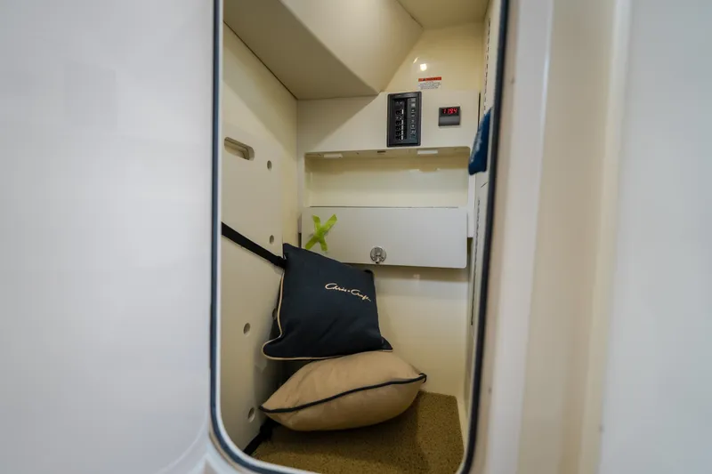 Slide: The Image of 2024 Chris-Craft Calypso 32 cabin interior with cushions and control panel. - 72