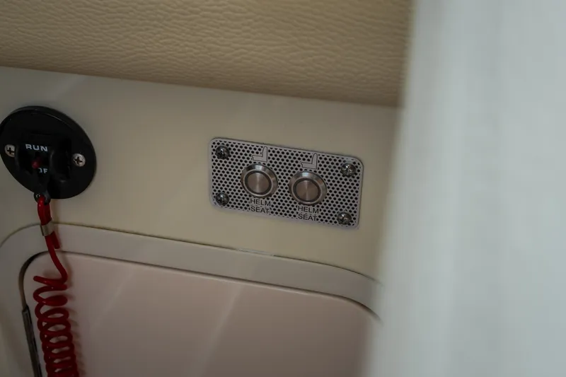 Slide: The Image of 2024 Chris-Craft Calypso 32 helm seat control panel with safety switch. - 74
