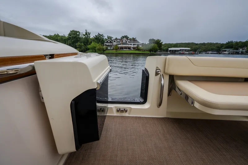 Slide: The Image of 2024 Chris-Craft Calypso 32 boat interior with lake view and luxurious seating. - 29