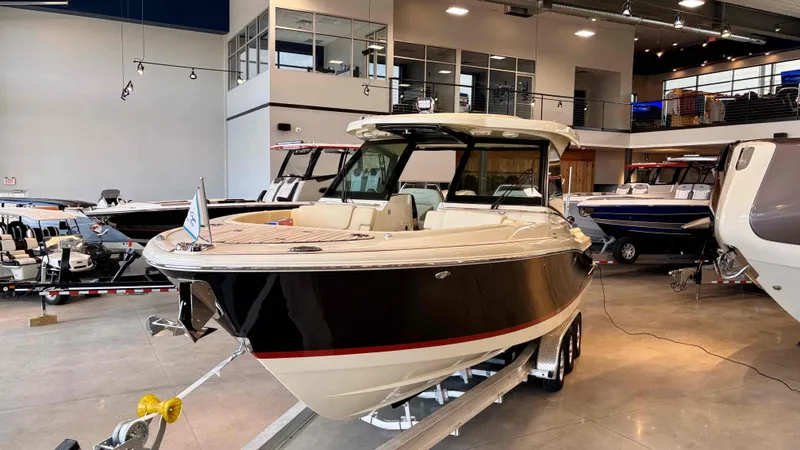 Slide: The Image of 2024 Chris-Craft Calypso 32 CT boat displayed in a showroom. - 9