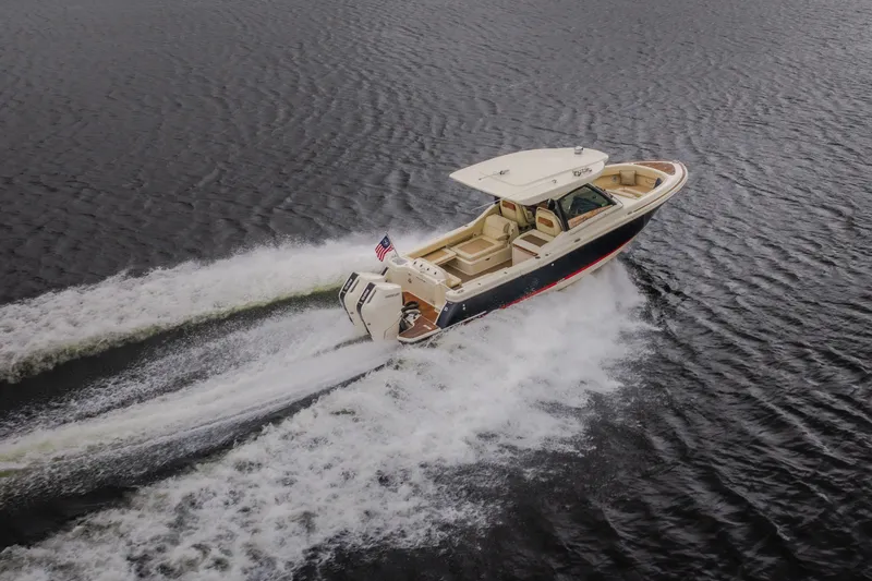 Slide: The Image of 2024 Chris-Craft Calypso 32 cruising on open water, showcasing sleek design and powerful performance. - 75