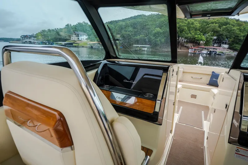 Slide: The Image of 2024 Chris-Craft Calypso 32 interior with luxurious seating and scenic lake view. - 45
