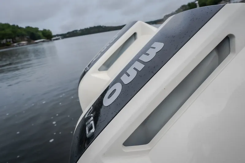 Slide: The Image of Close-up of 2024 Chris-Craft Calypso 32 boat engines on a calm lake. - 18