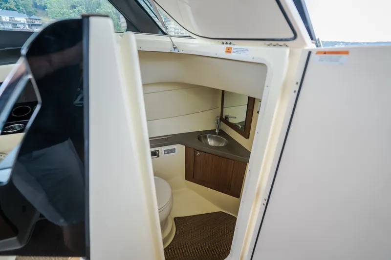 Slide: The Image of 2024 Chris-Craft Calypso 32 boat interior with compact bathroom and sink. - 70