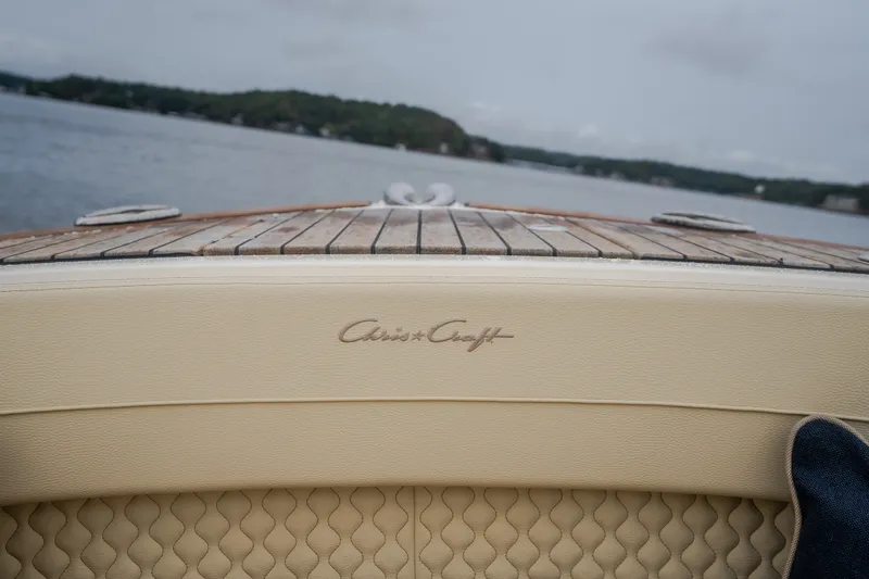 Slide: The Image of 2024 Chris-Craft Calypso 32 boat with elegant leather seating and wooden deck. - 53