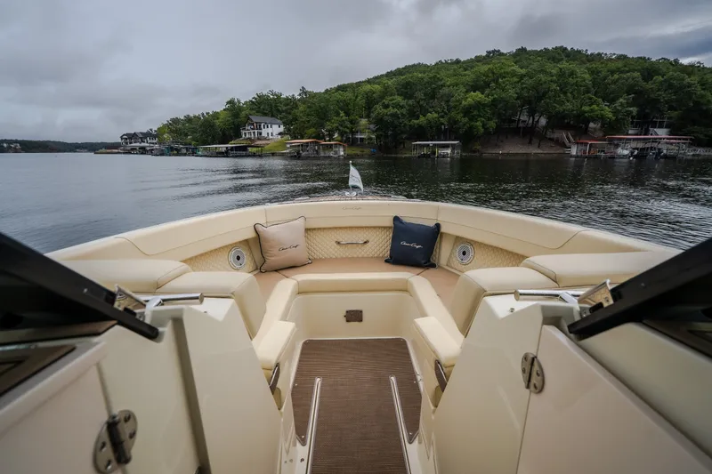 Slide: The Image of 2024 Chris-Craft Calypso 32 boat interior with luxurious seating on a serene lake. - 49