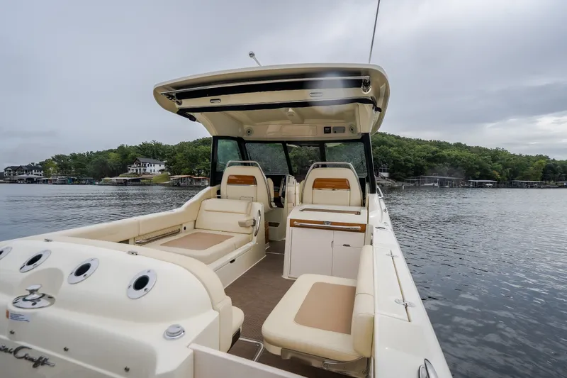 Slide: The Image of 2024 Chris-Craft Calypso 32 boat interior with seating, on a serene lake backdrop. - 21
