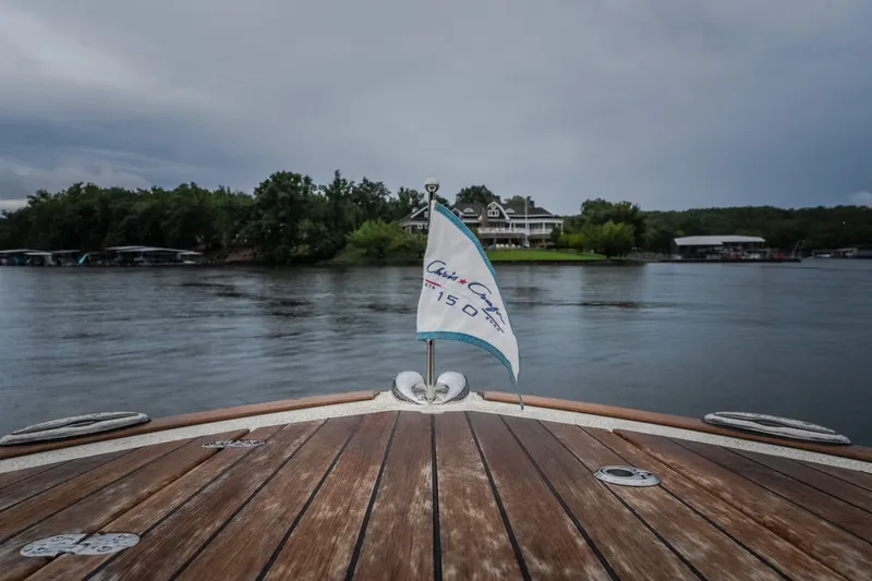 Slide: The Image of 2024 Chris-Craft Calypso 32 boat on a lake with scenic shoreline view. - 68