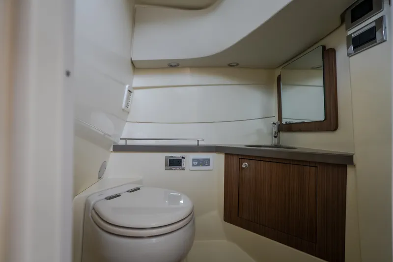 Slide: The Image of 2024 Chris-Craft Calypso 32 boat bathroom with modern fixtures and wood accents. - 71