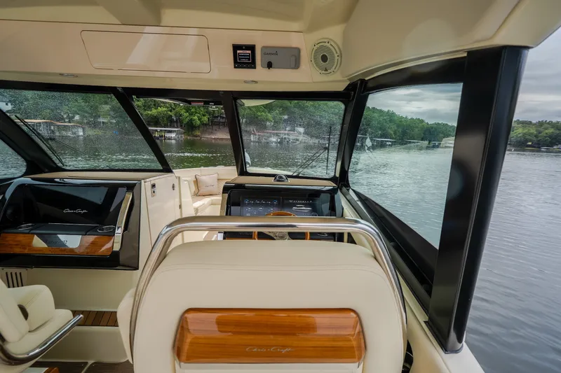 Slide: The Image of Interior view of 2024 Chris-Craft Calypso 32 boat, featuring luxurious seating and modern dashboard. - 30