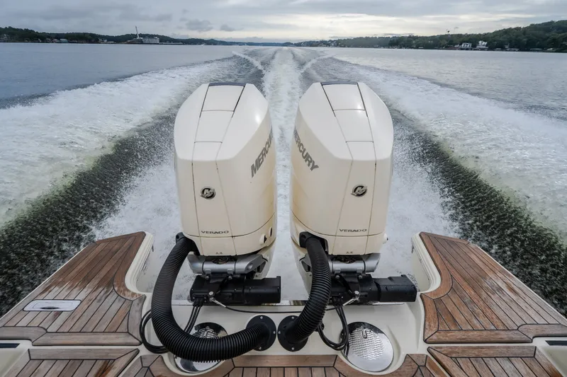 Slide: The Image of 2024 Chris-Craft Calypso 32 with dual Mercury Verado engines cruising on open water. - 64