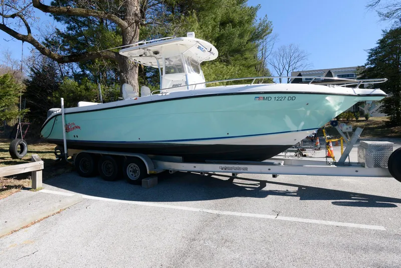 The Image of 2008 Century 2901 Center Console boat on a trailer, parked outdoors. - 0