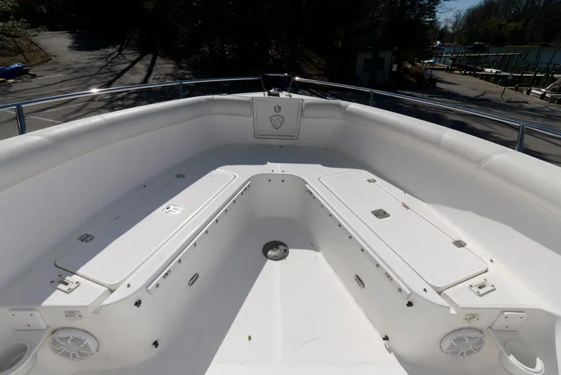 Slide: The Image of 2008 Century 2901 Center Console boat interior with white seating and storage compartments. - 11