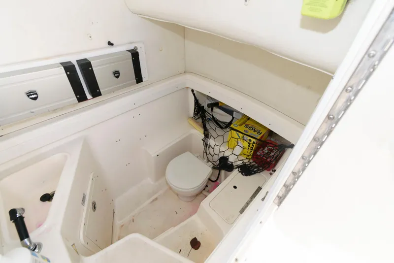 Slide: The Image of 2008 Century 2901 Center Console boat interior with storage and toilet. - 14