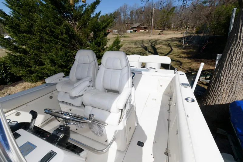 Slide: The Image of 2008 Century 2901 Center Console boat with dual seats and steering wheel, parked outdoors. - 4