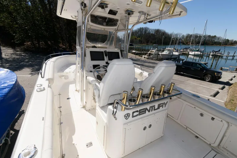 Slide: The Image of 2008 Century 2901 Center Console boat with dual seats, docked near a marina. - 5