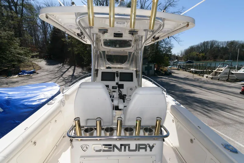 Slide: The Image of 2008 Century 2901 Center Console boat with dual seats and rod holders, docked outdoors. - 6