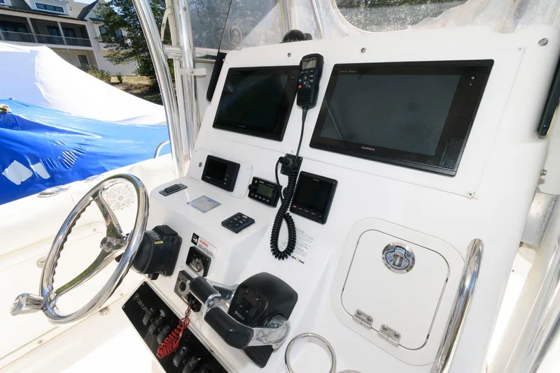 Slide: The Image of 2008 Century 2901 Center Console boat dashboard with steering wheel and navigation equipment. - 8