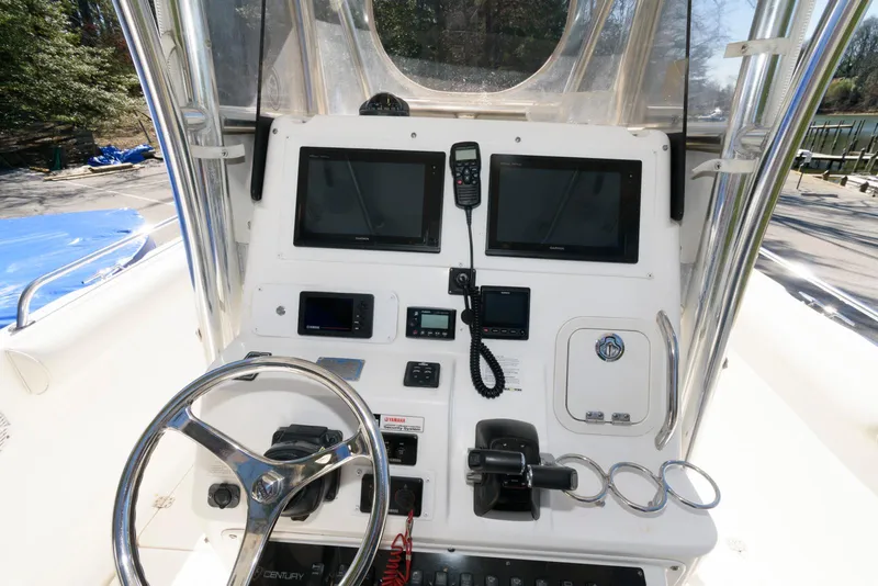 Slide: The Image of 2008 Century 2901 Center Console boat dashboard with steering wheel and navigation equipment. - 9