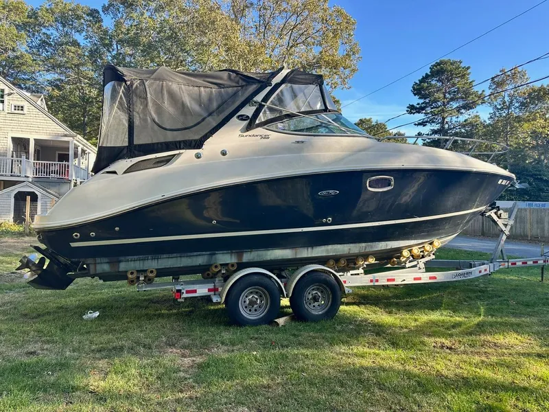 The Image of 2013 Sea Ray 280 Sundancer boat on trailer, parked on grass. - 1