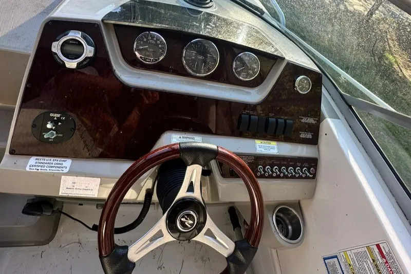 Slide: The Image of 2013 Sea Ray 280 Sundancer dashboard with steering wheel and instrument panel. - 10