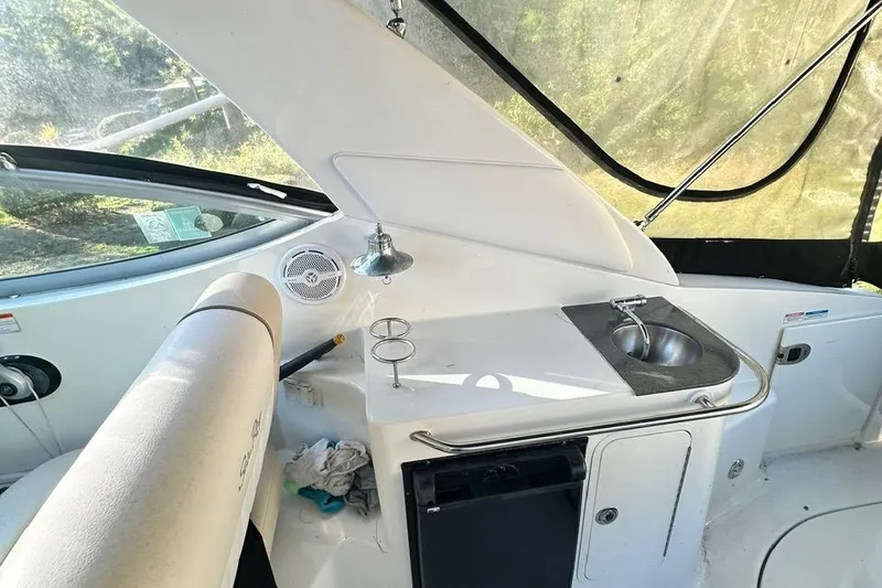 Slide: The Image of 2013 Sea Ray 280 Sundancer boat interior with sink and seating area. - 12