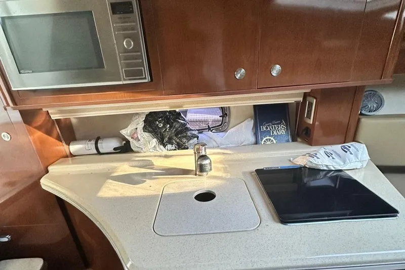 Slide: The Image of 2013 Sea Ray 280 Sundancer cabin kitchen with microwave and countertop. - 15