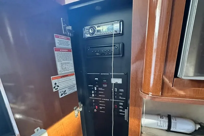Slide: The Image of Control panel inside 2013 Sea Ray 280 Sundancer boat with stereo system and safety instructions. - 18