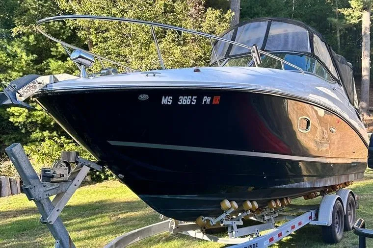 Slide: The Image of 2013 Sea Ray 280 Sundancer boat on trailer, parked on grass with trees in background. - 5