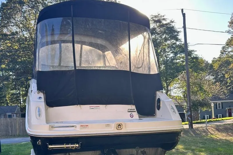 Slide: The Image of 2013 Sea Ray 280 Sundancer boat with black canvas cover, parked outdoors. - 8