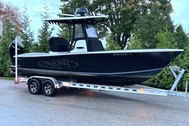 Slide: The Image of 1975 SeaCraft 23 Potter Hull boat on trailer, parked outdoors. - 0