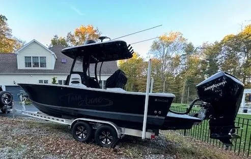 Slide: The Image of 1975 SeaCraft 23 Potter Hull boat on trailer, parked near a house. - 1