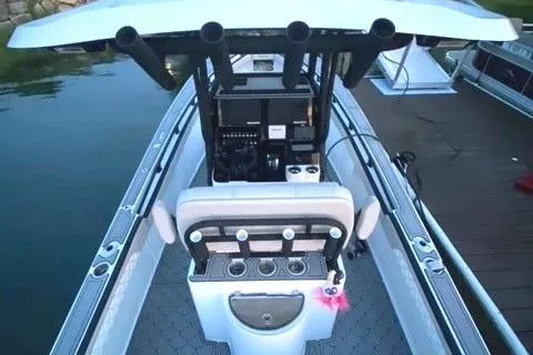 Slide: The Image of 1975 SeaCraft 23 Potter Hull boat interior with fishing rod holders and console. - 2